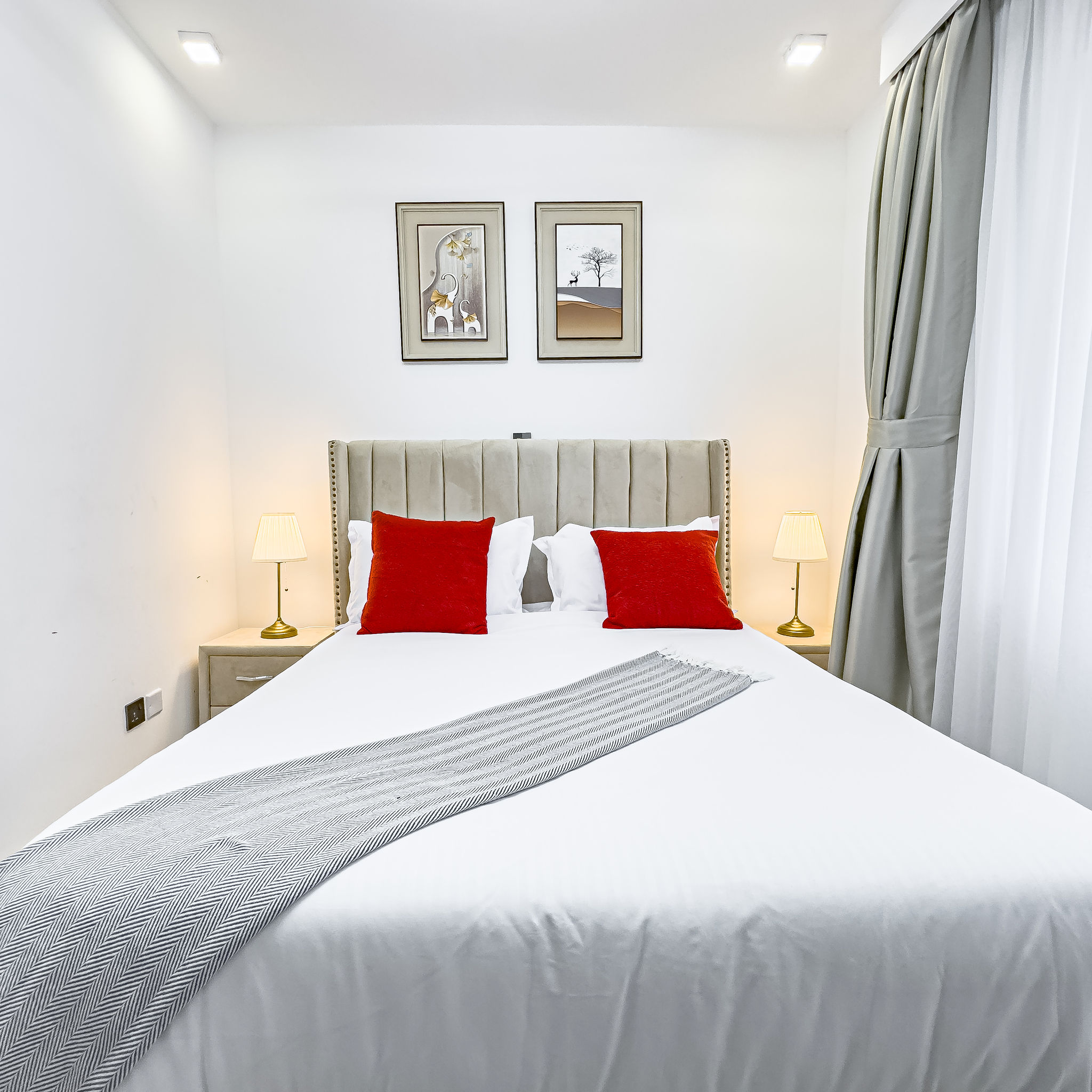 Bedroom with upholstered headboard and warm lighting