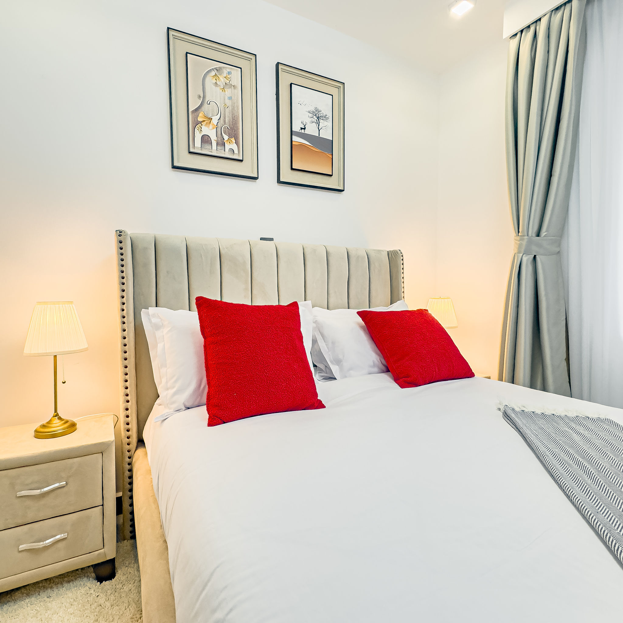 Bedroom detail with wall art and bedside lamps