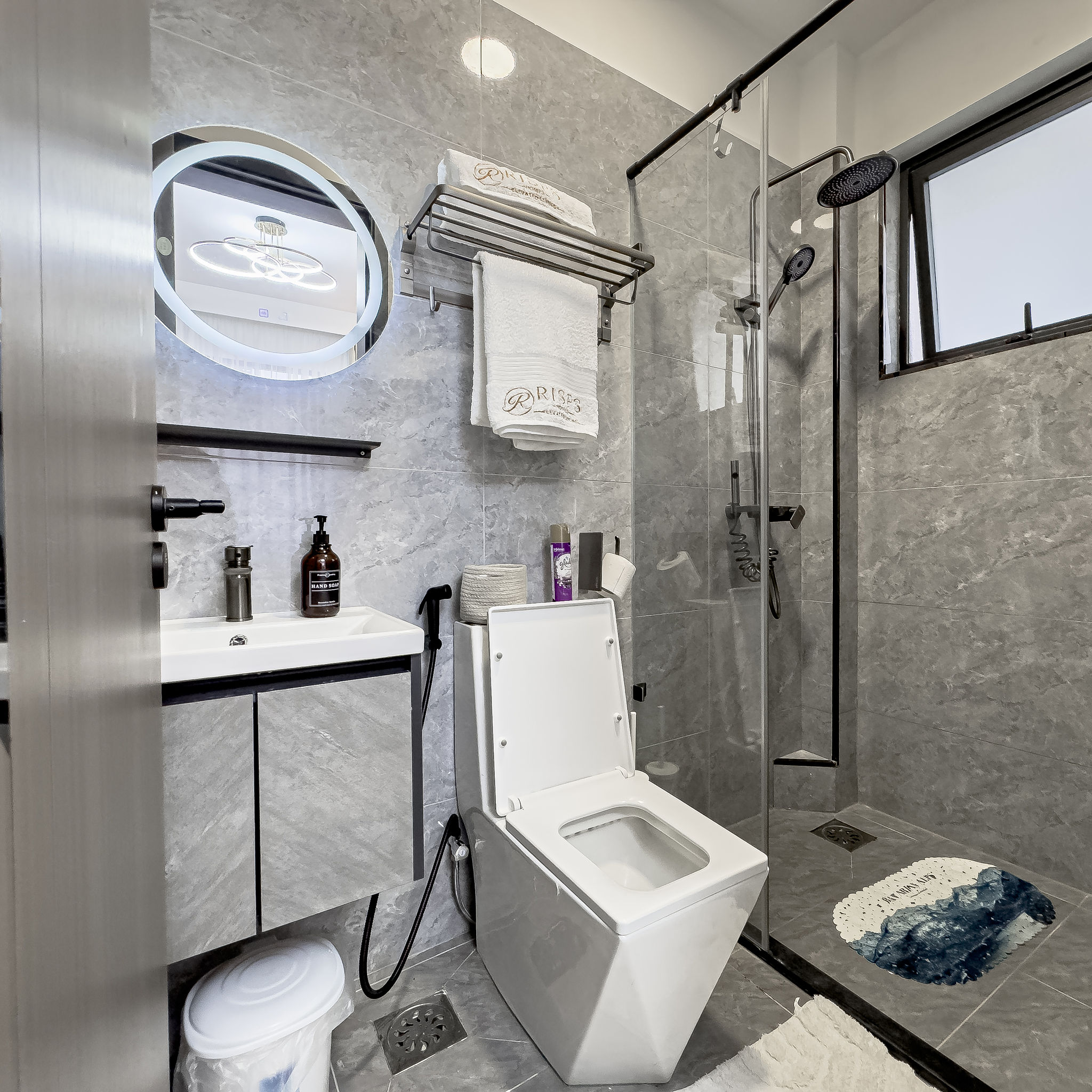 Modern bathroom with walk-in shower and LED mirror