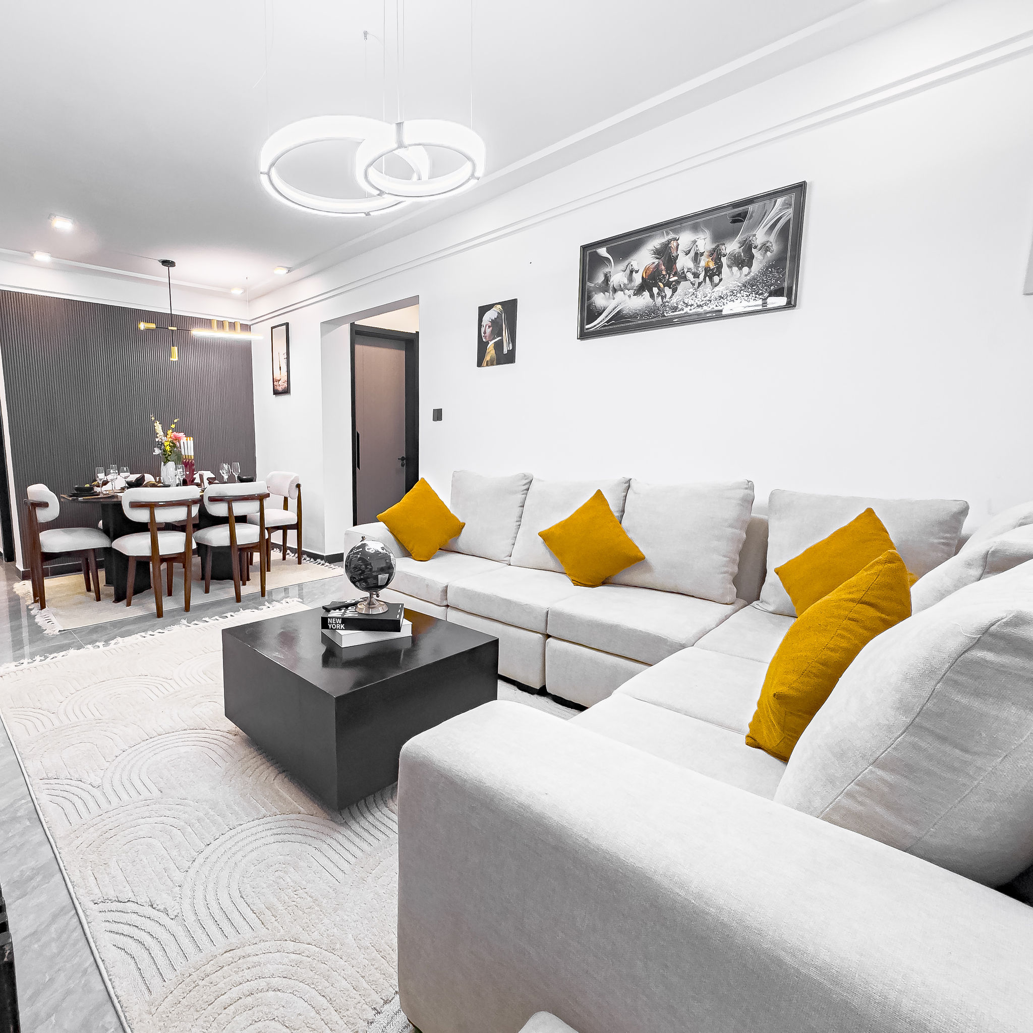 Open-plan living room with L-shaped sofa and dining area