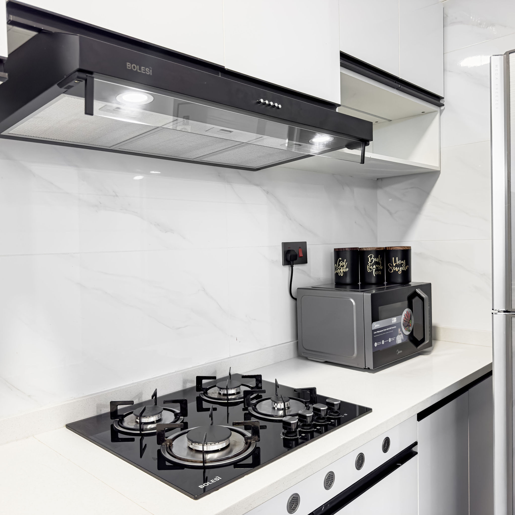 Modern kitchen with gas hob and appliances