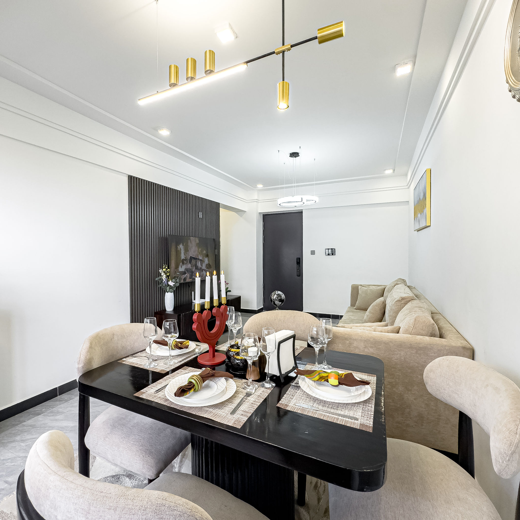 Dining area with table settings and living room beyond