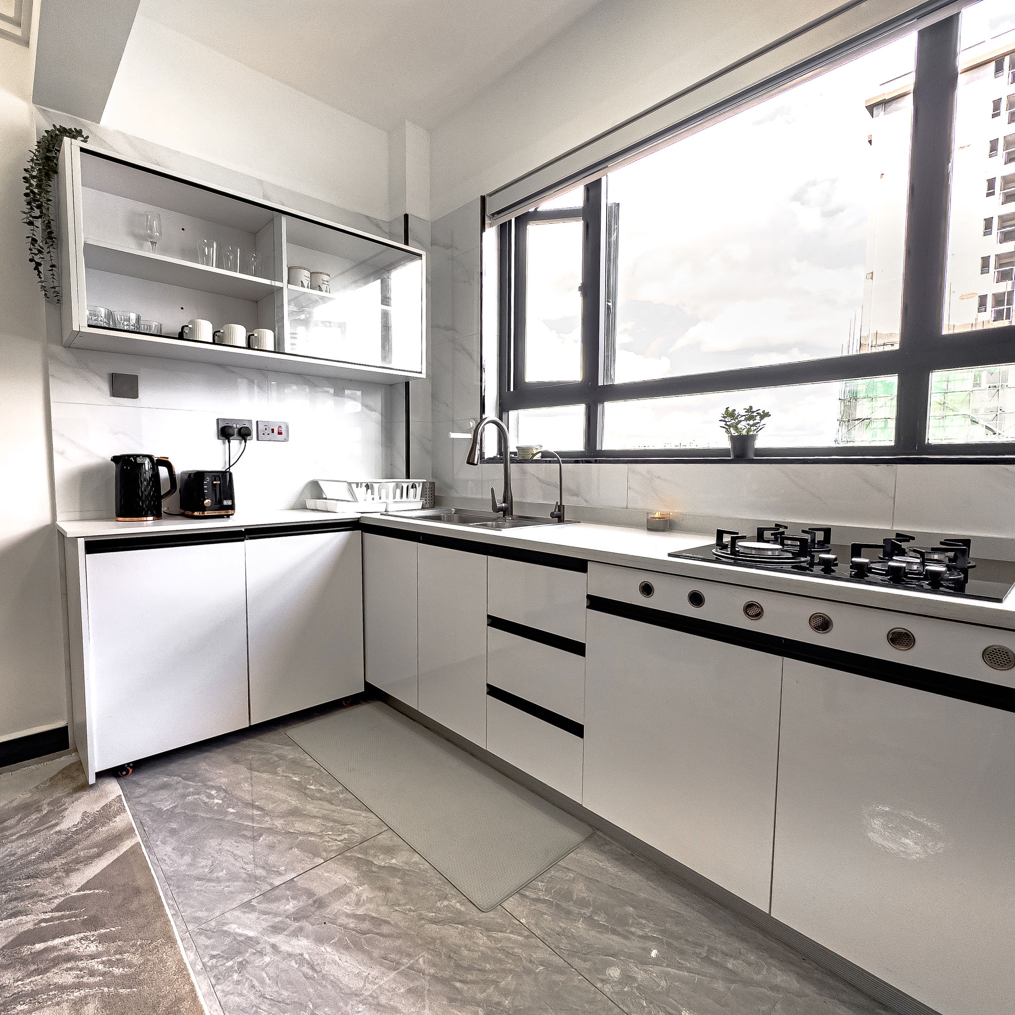 L-shaped kitchen with window and modern appliances